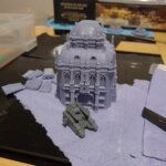 A loosely put together 3d printed Grim Dark Terrain scenery piece with Sicaran